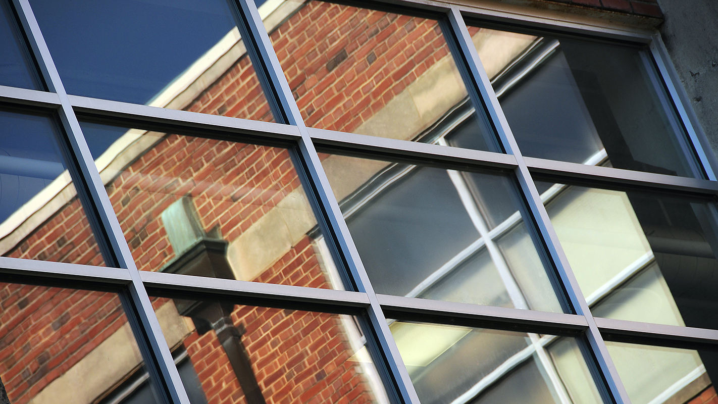 Windows reflect Nelson Hall.