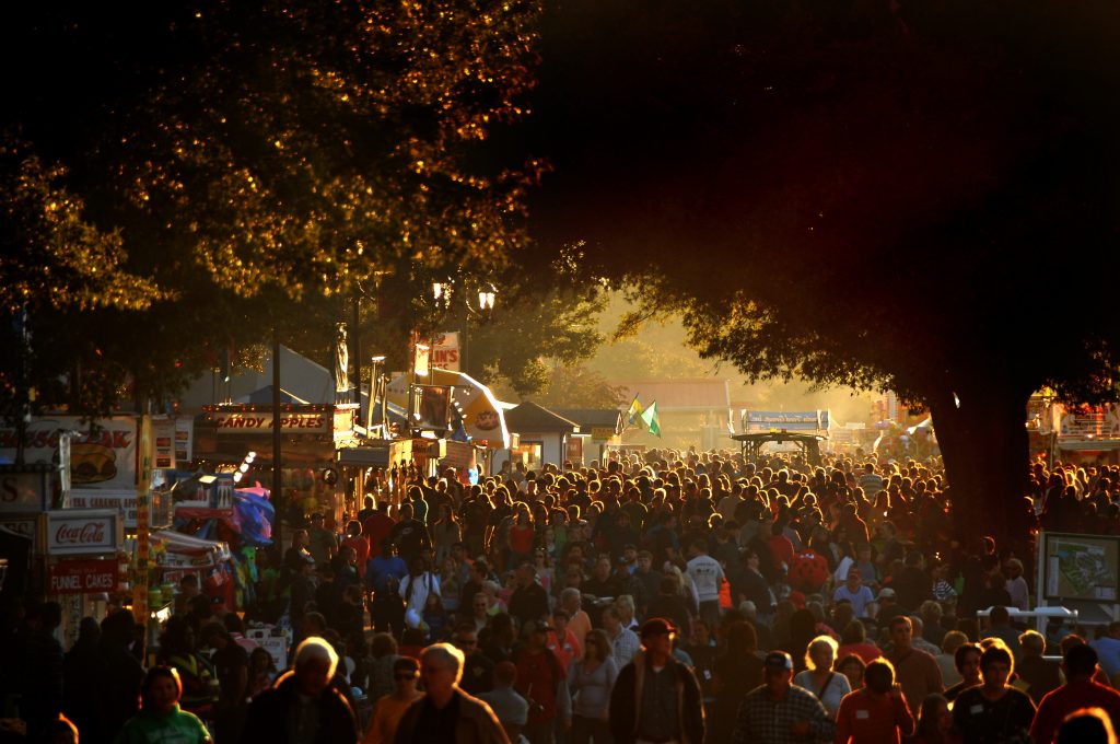 温暖的秋日灯光照亮了广场上的一大群游览者。