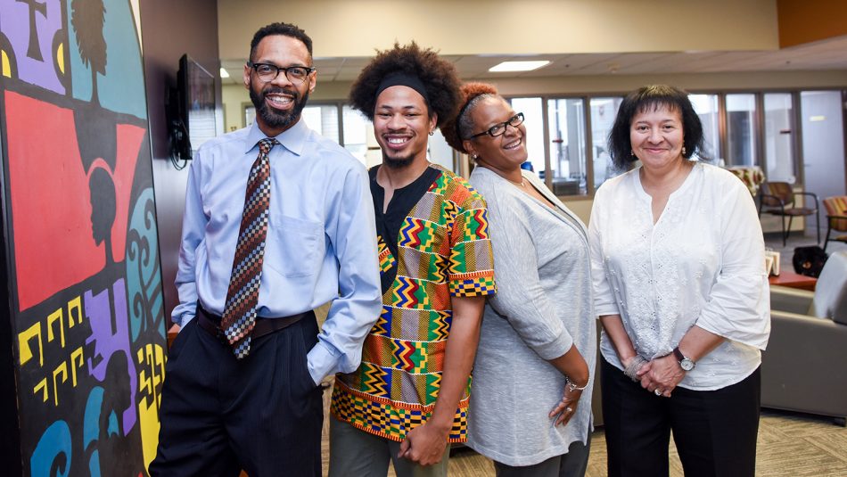 该中心的员工在他们的办公室在滨海学生中心的三楼。从左到右：Moses T. Alexander Greene，John Miller IV，Tonya Hines和Angela Jenkins（未图片：Sachelle Ford）。