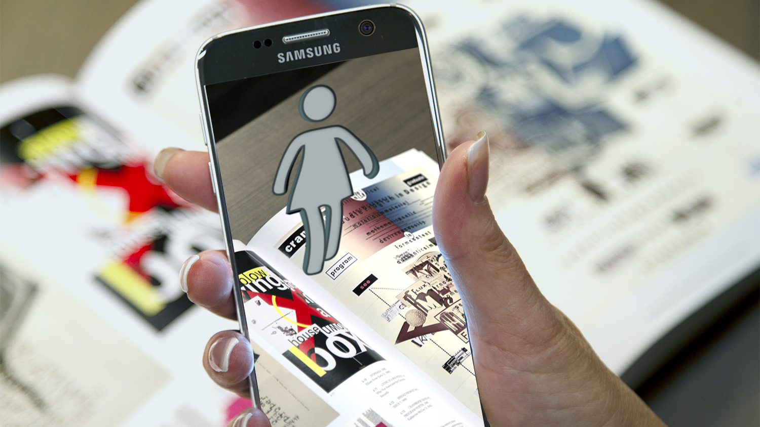 在教科书上手持手机的图像