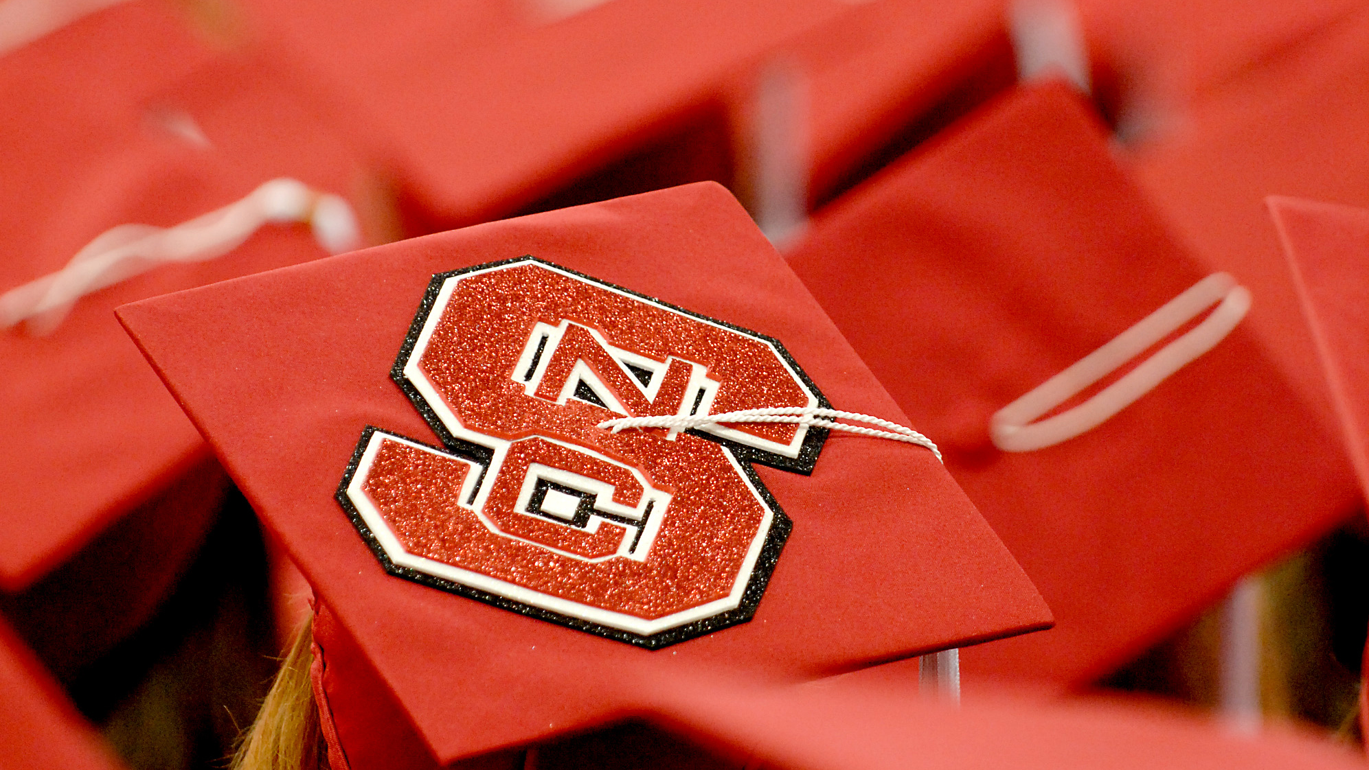毕业帽的镜头，包括一顶NC州立标志