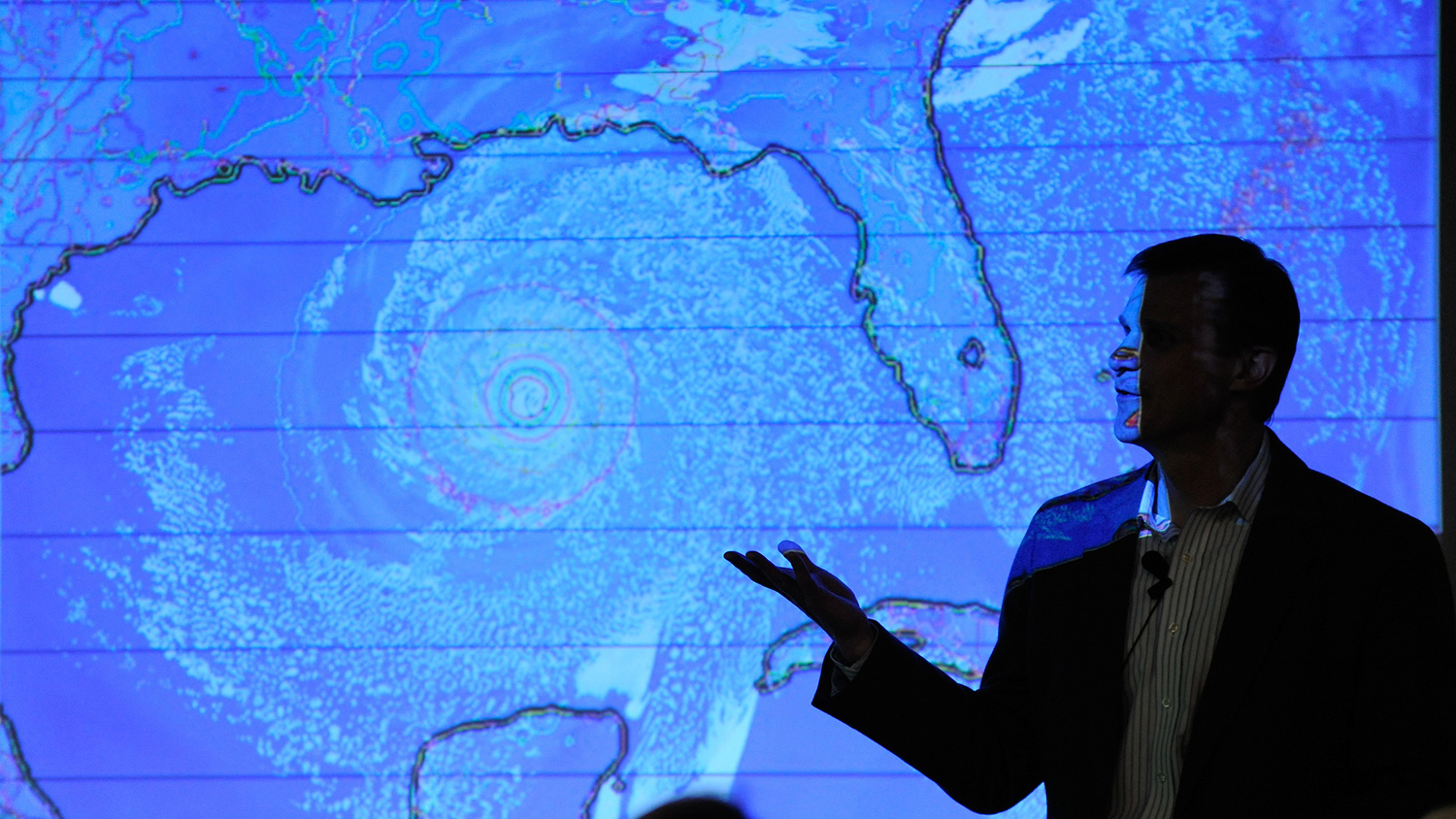 一个人剪影反对显示飓风的天气图