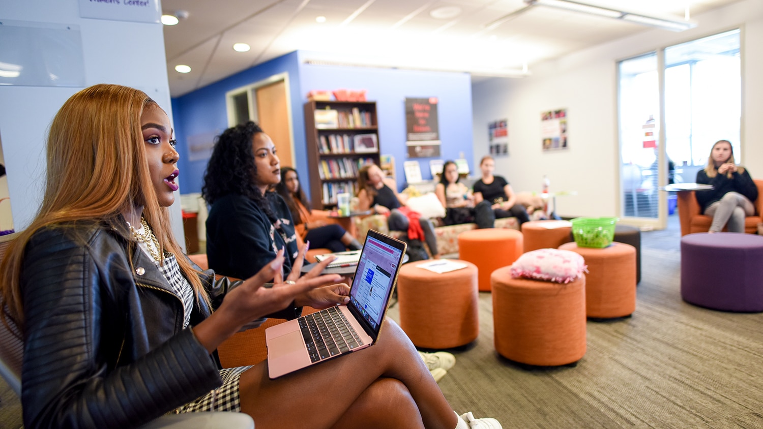 A group of students engages in discussion at the NC State Women's Center.
