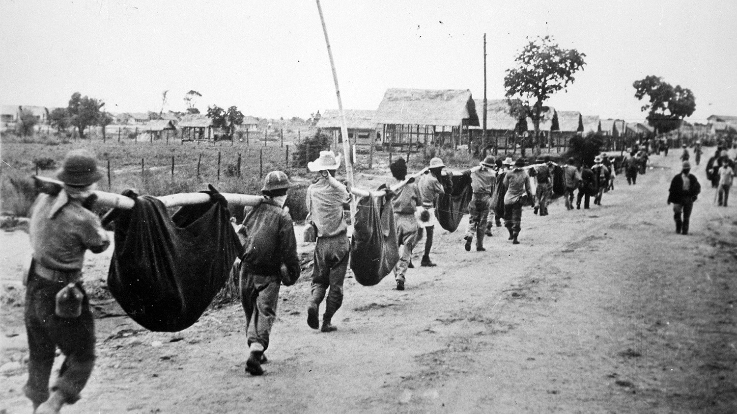 美国军人走向菲律宾马尼拉附近的一个战俘营。