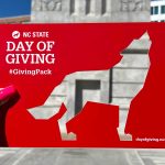 A Day of Giving frame with a wolf cutout.