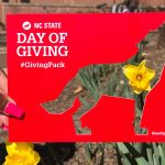 A Day of Giving frame with a wolf cutout.