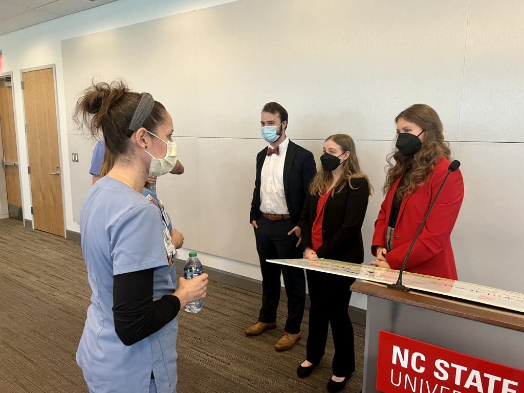 Team of nurses from UNC Children's Hospital speak with 2022 K2C race directors at the $2M celebration.