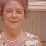 A color photo of an adult Mary Yarbrough captures her in a candid moment as she smiles at the camera.